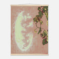 Framed artwork with a moon and plant design on a pink background
