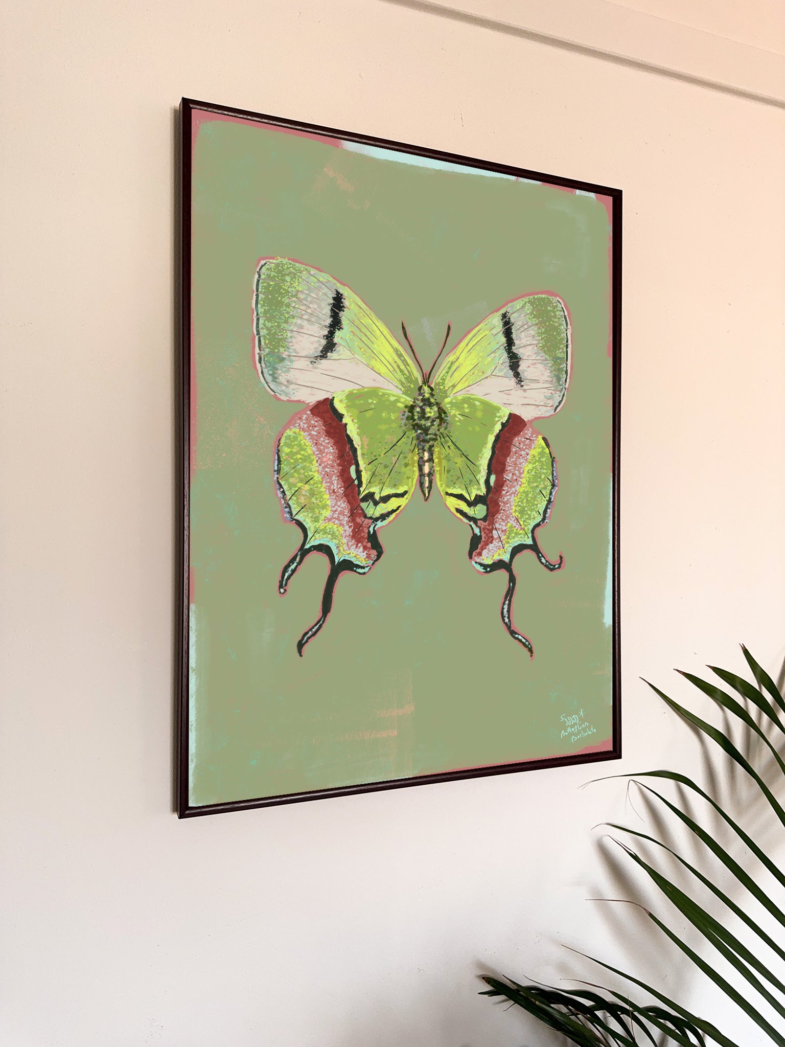 Framed artwork of a green butterfly on a light green background
