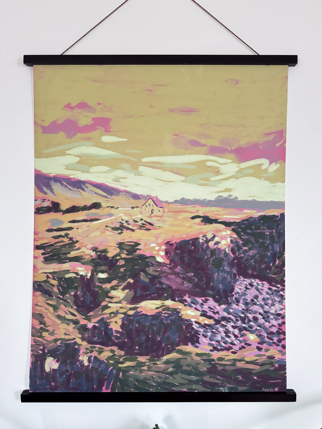 Artistic landscape painting with a house on a hill, framed as a wall hanging.