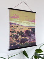 Artistic Icelandic landscape print on a wall with a plant in the foreground