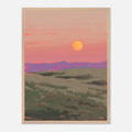 Framed artwork of a sunset over rolling hills with a warm color palette.