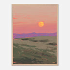 Framed artwork of a sunset over rolling hills with a warm color palette.