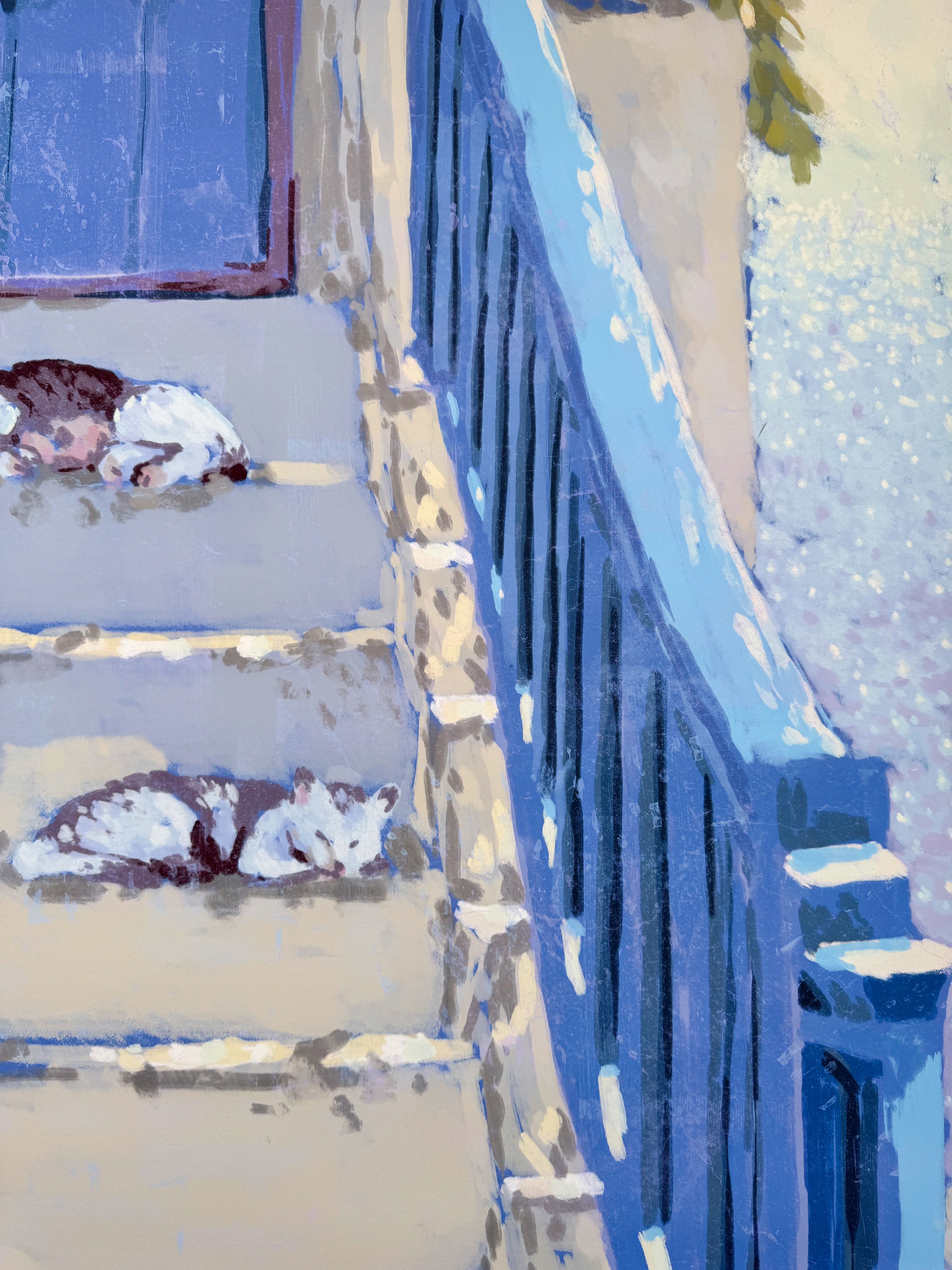 Two cats sleeping on a set of stairs with a blue railing.