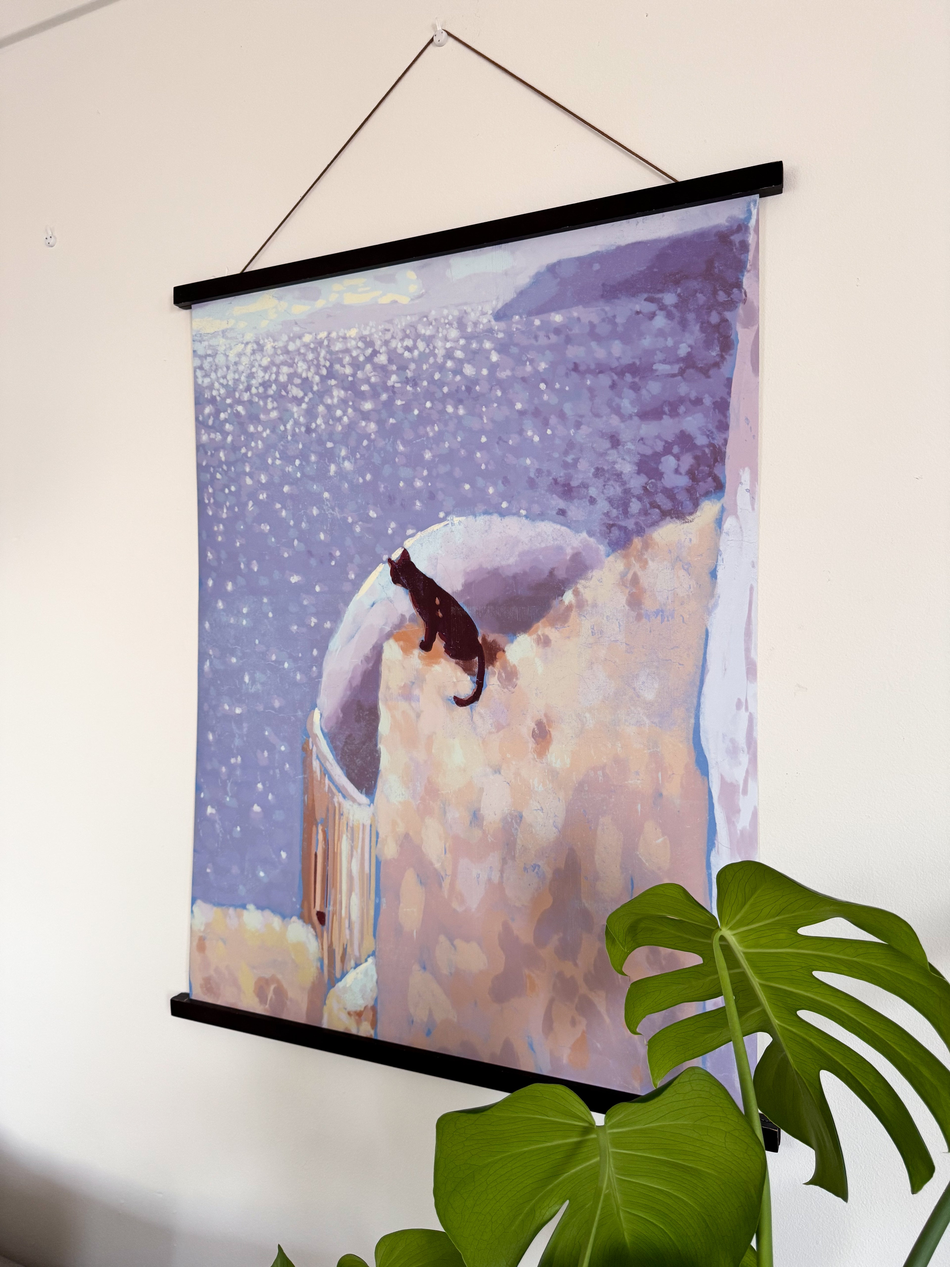 Wall-mounted poster of a cat on a roof with the sea in the foreground