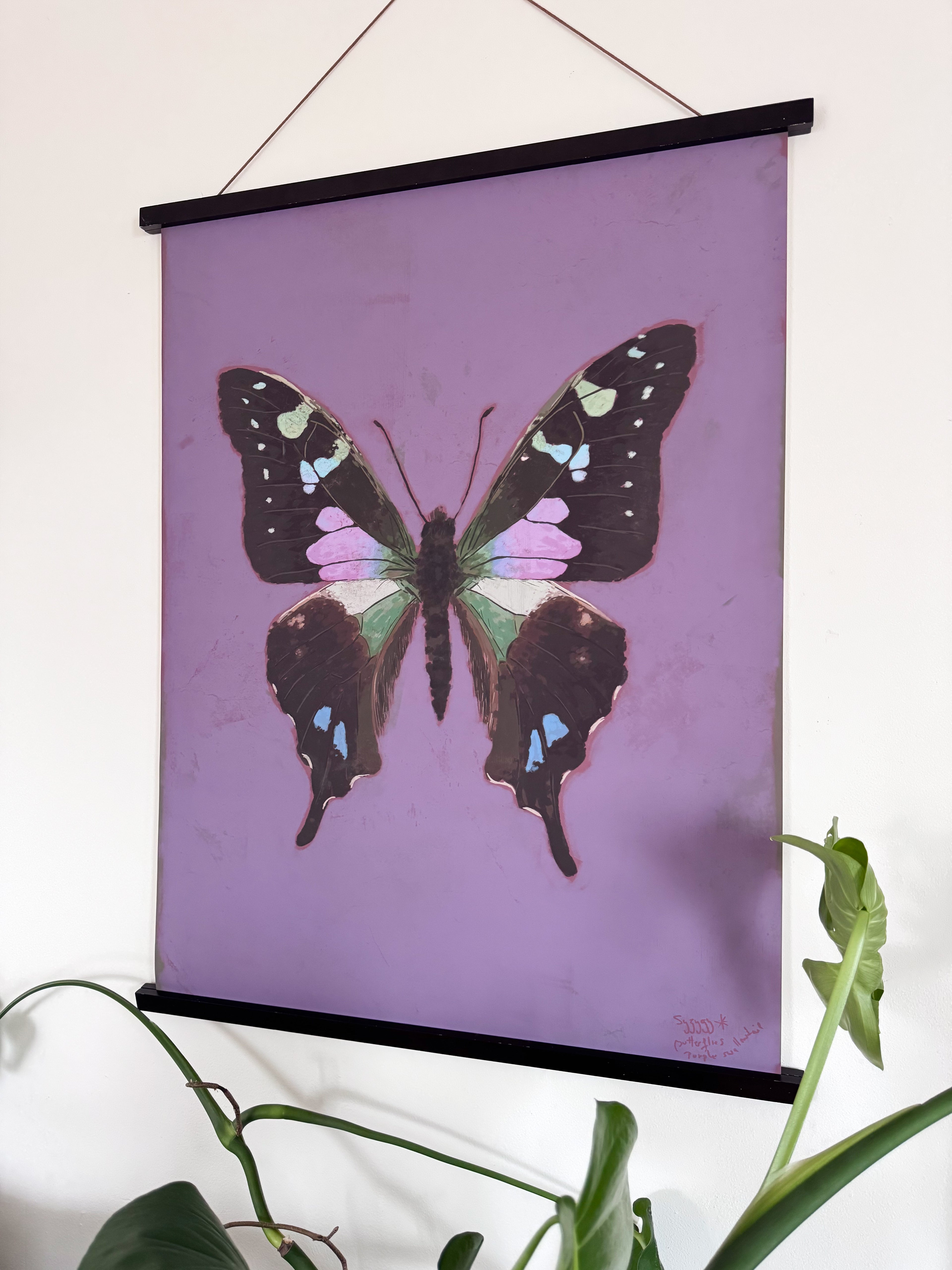 Butterfly artwork on a purple background with a plant in the foreground