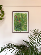Framed artwork of a garden scene on a wall with plants around
