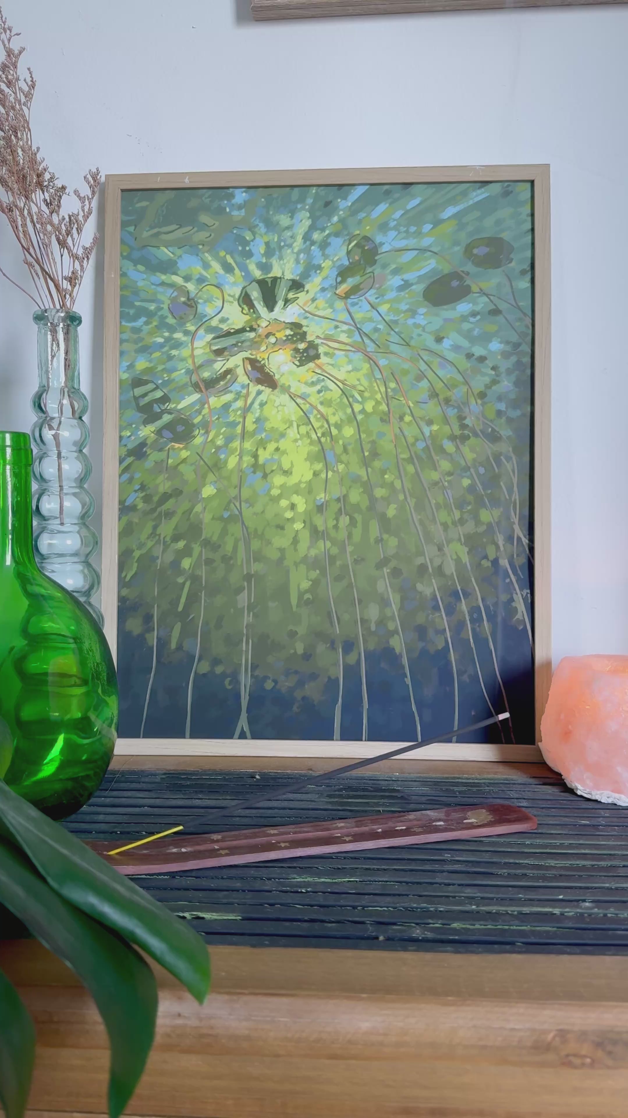 Video of an impressionistic art print of a lake and lily pads in green colors